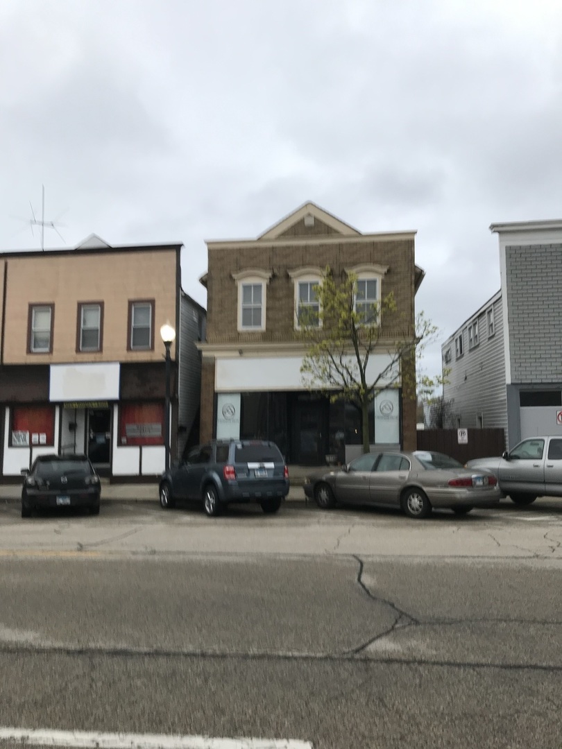 3929 Main Street, Unit 2 McHenry, IL 60050 - Photo 2 of 17 a view of a street that has couple of cars parked on the road