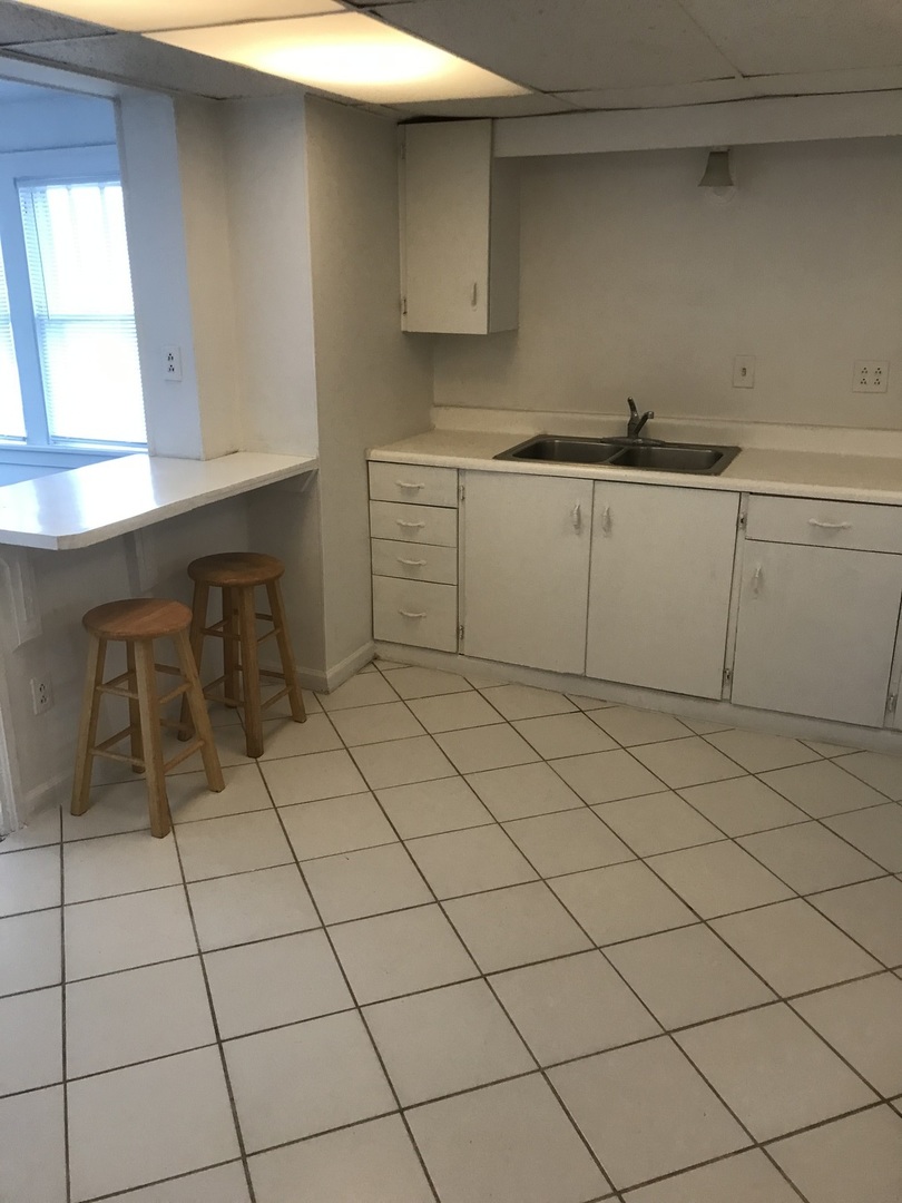 3929 Main Street, Unit 2 McHenry, IL 60050 - Photo 5 of 17 a kitchen with a sink and cabinets