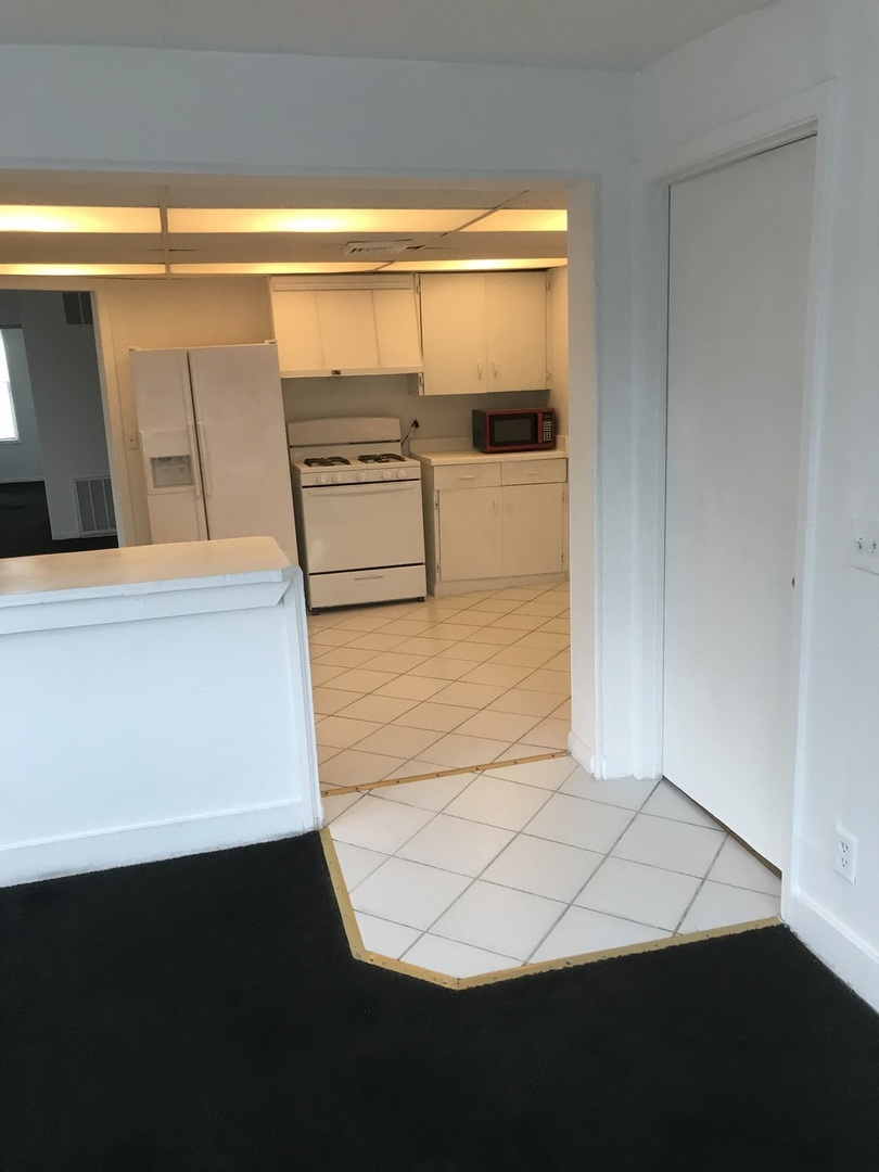 3929 Main Street, Unit 2 McHenry, IL 60050 - Photo 9 of 17 a view of a living room with furniture and wooden floor