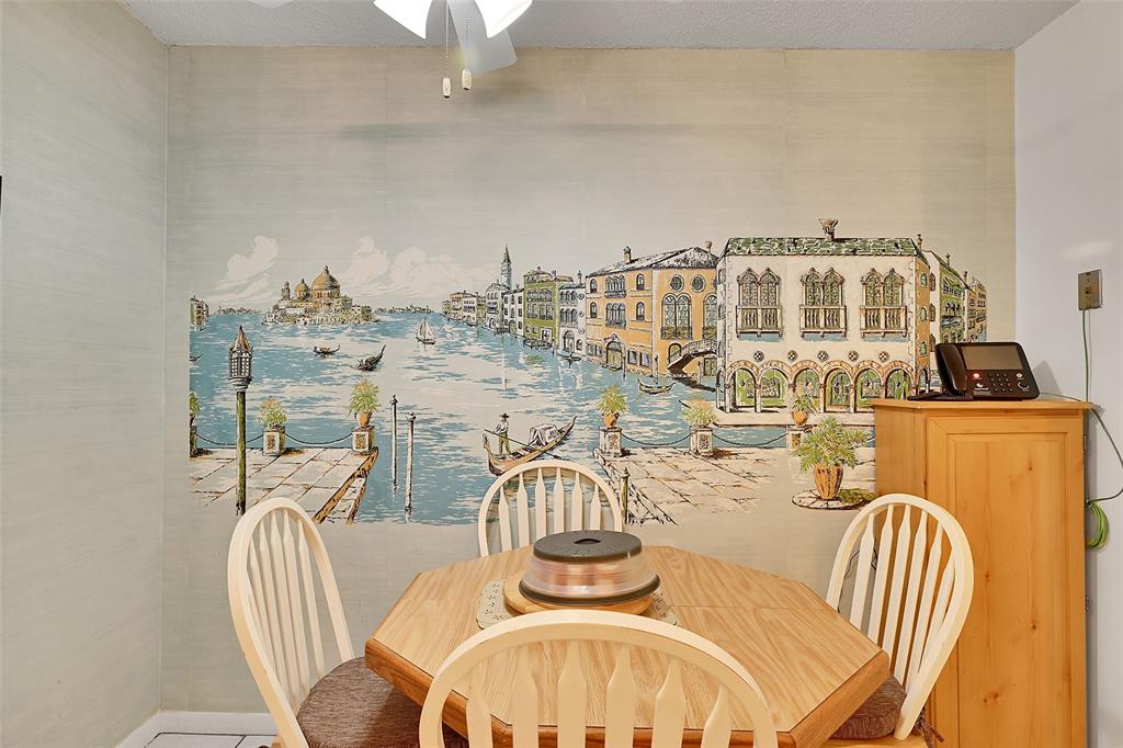 401 Briny Avenue, Unit 409 Pompano Beach, FL 33062 - Photo 18 of 62 a view of a dining room with furniture and wooden floor