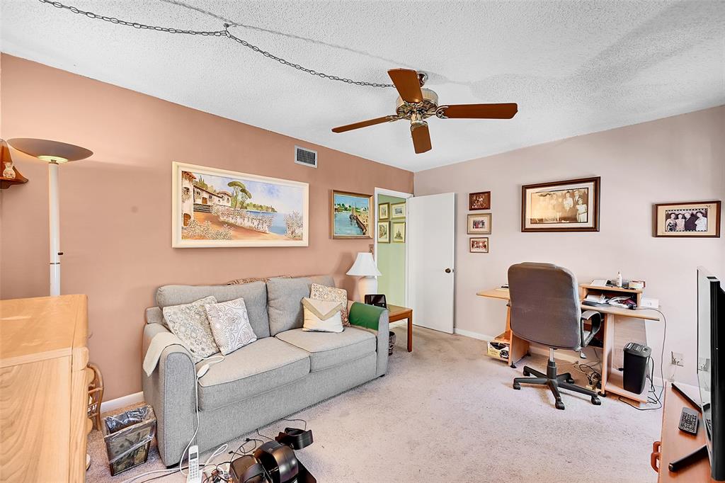401 Briny Avenue, Unit 409 Pompano Beach, FL 33062 - Photo 29 of 62 a living room with furniture and a ceiling fan