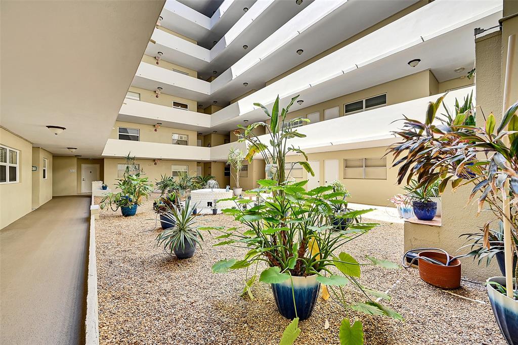 401 Briny Avenue, Unit 409 Pompano Beach, FL 33062 - Photo 41 of 62 a dining room with furniture and a potted plant