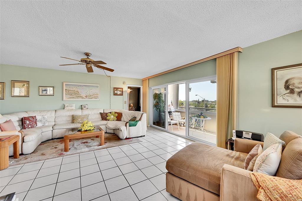 401 Briny Avenue, Unit 409 Pompano Beach, FL 33062 - Photo 10 of 62 a living room with furniture and a large window