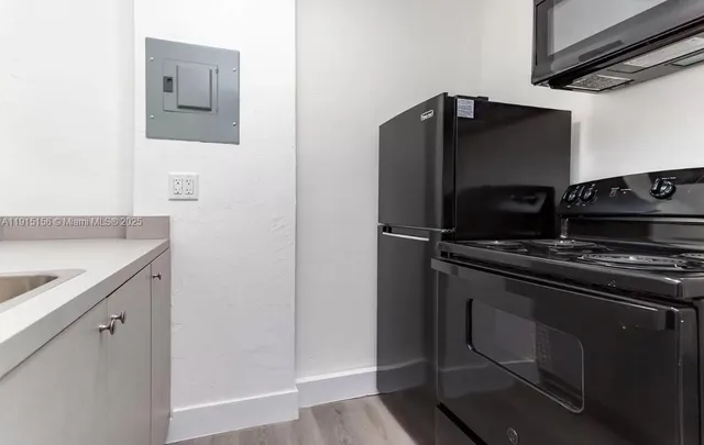 a kitchen with a refrigerator and a stove