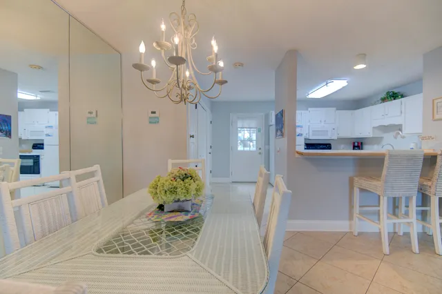 a dining room with kitchen island granite countertop furniture and a chandelier