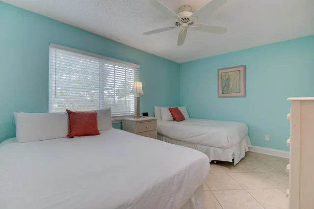 a bedroom with two beds and a chandelier