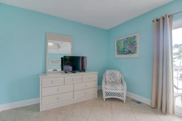 a room with a bed and a television