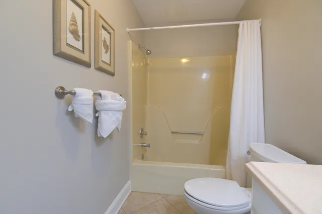 a bathroom with a shower a toilet and sink