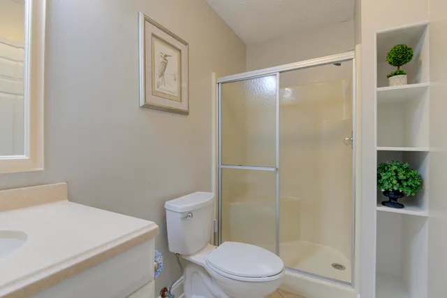 a white toilet sitting next to a bathroom sink