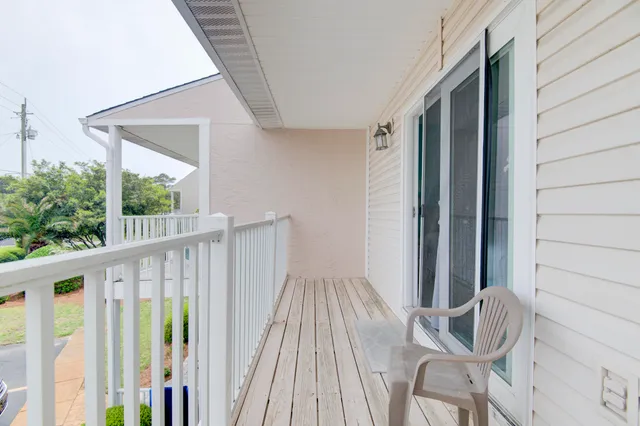 a view of balcony with wooden floor and seating space