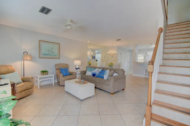 a living room with furniture and a painting on the wall