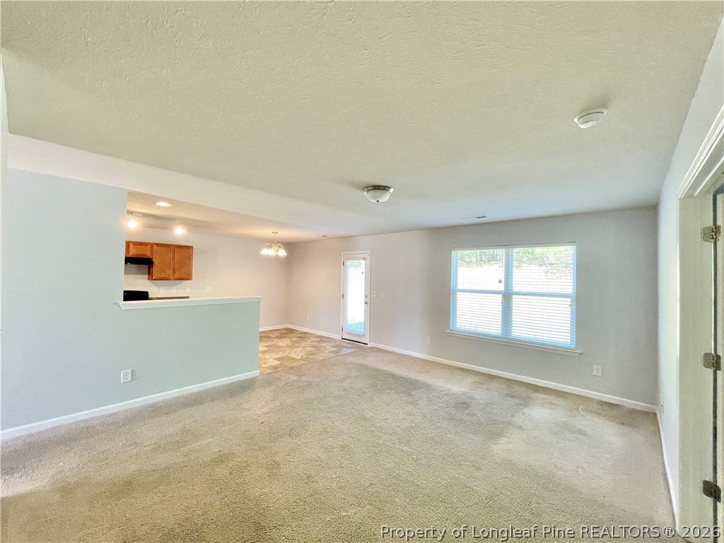 92 Hallow Oak Street Spring Lake, NC 28390 - Photo 6 of 11 an empty room with windows and fireplace