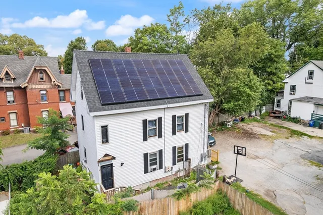 a aerial view of a house with a yard