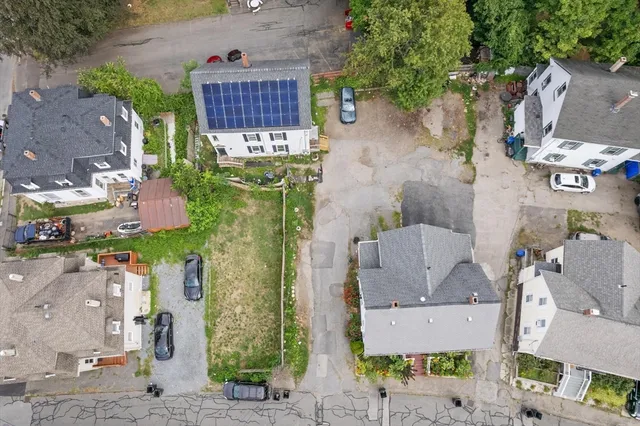 an aerial view of residential houses with outdoor space