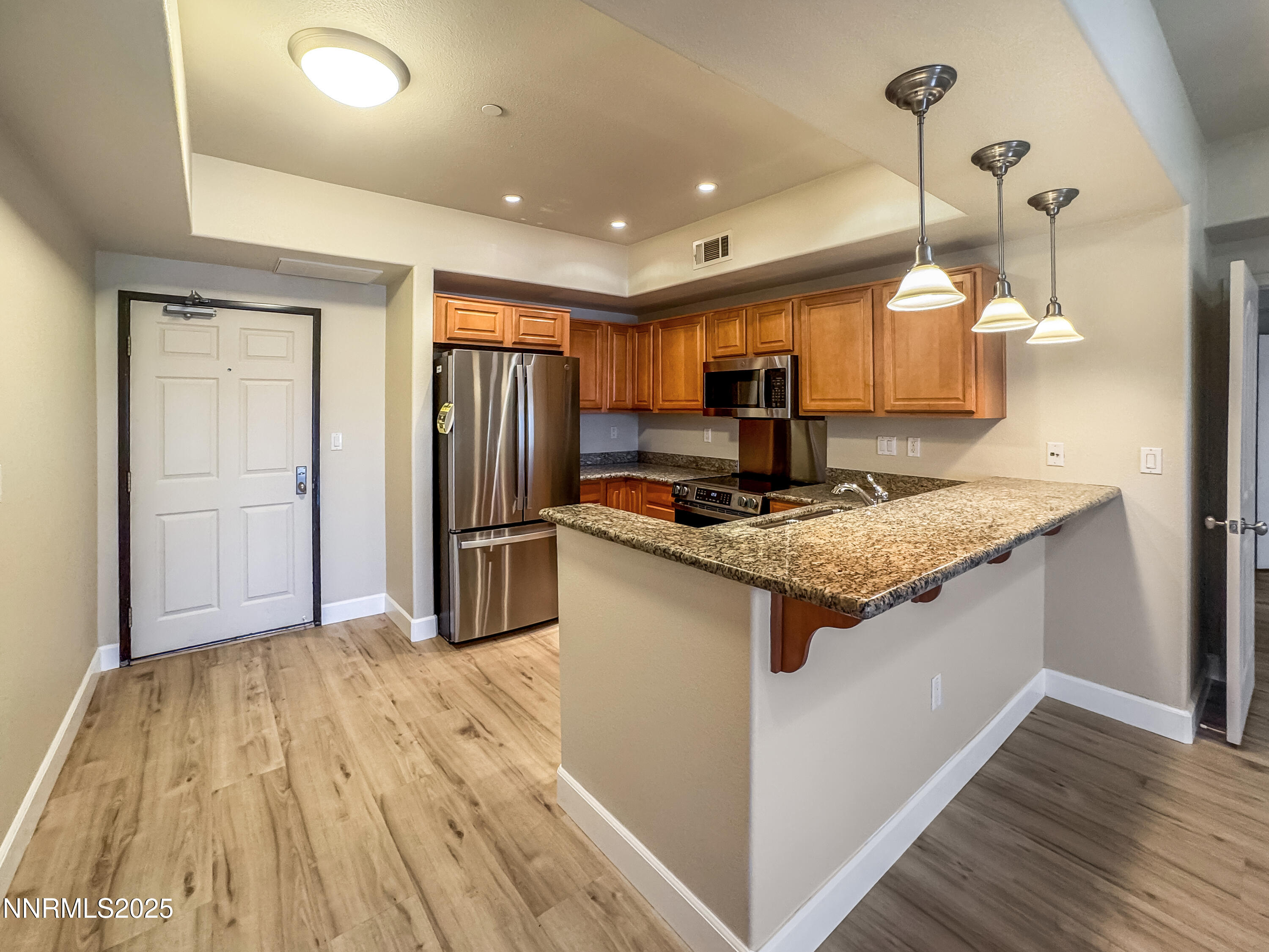 200 West 2nd Street, Unit 1107 Reno, NV 89501 - Photo 1 of 29 a kitchen with stainless steel appliances granite countertop a sink and a refrigerator