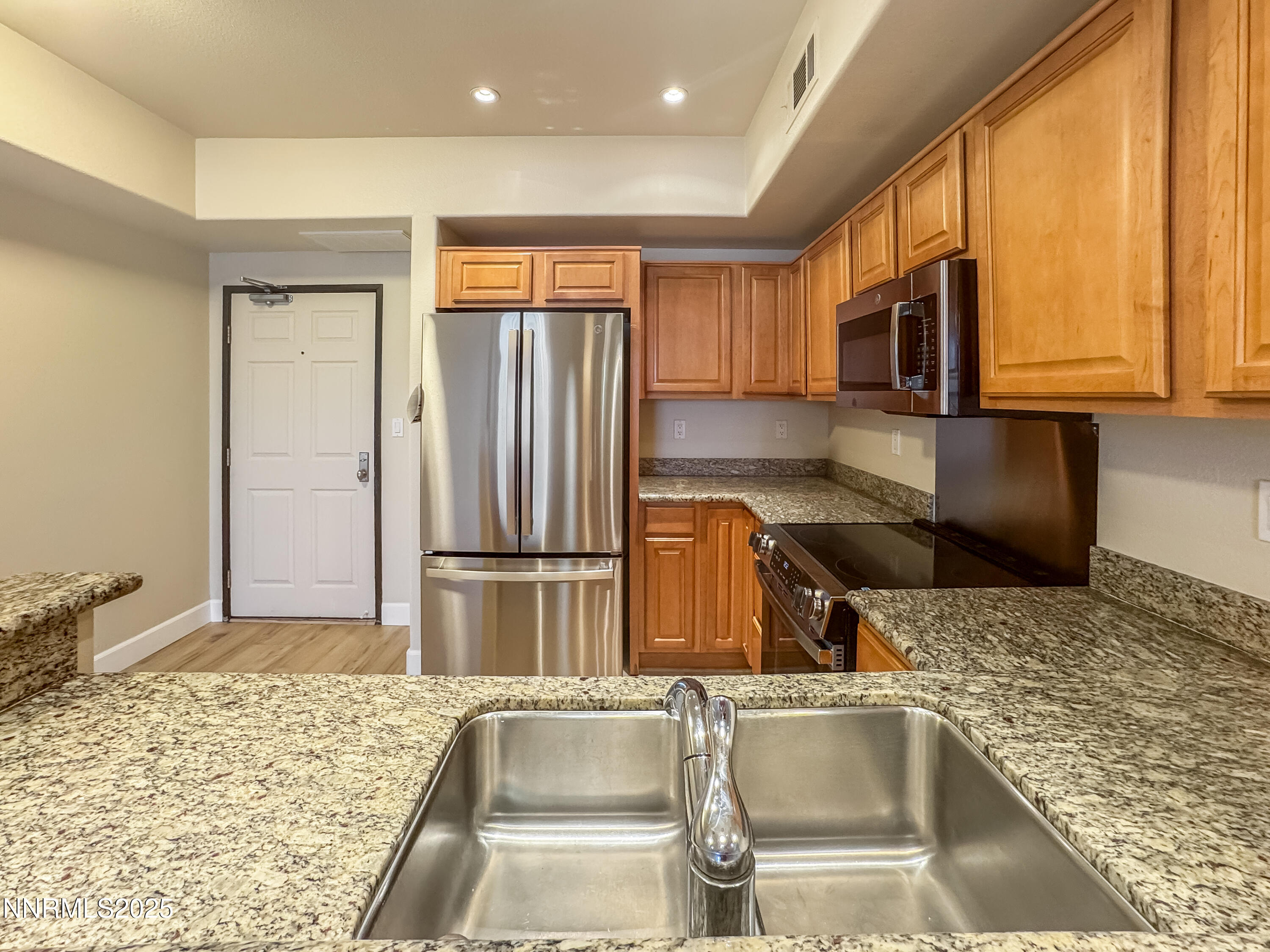 200 West 2nd Street, Unit 1107 Reno, NV 89501 - Photo 2 of 29 a kitchen with a refrigerator sink and cabinets