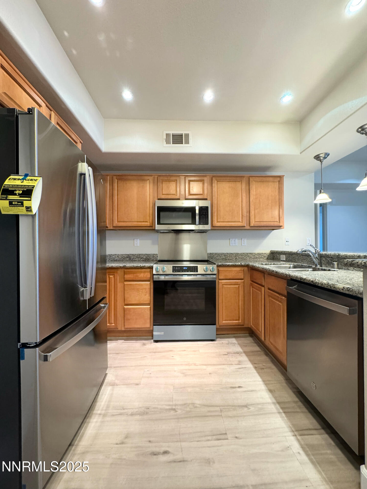 200 West 2nd Street, Unit 1107 Reno, NV 89501 - Photo 3 of 29 a kitchen with stainless steel appliances kitchen island granite countertop a stove a refrigerator and a sink