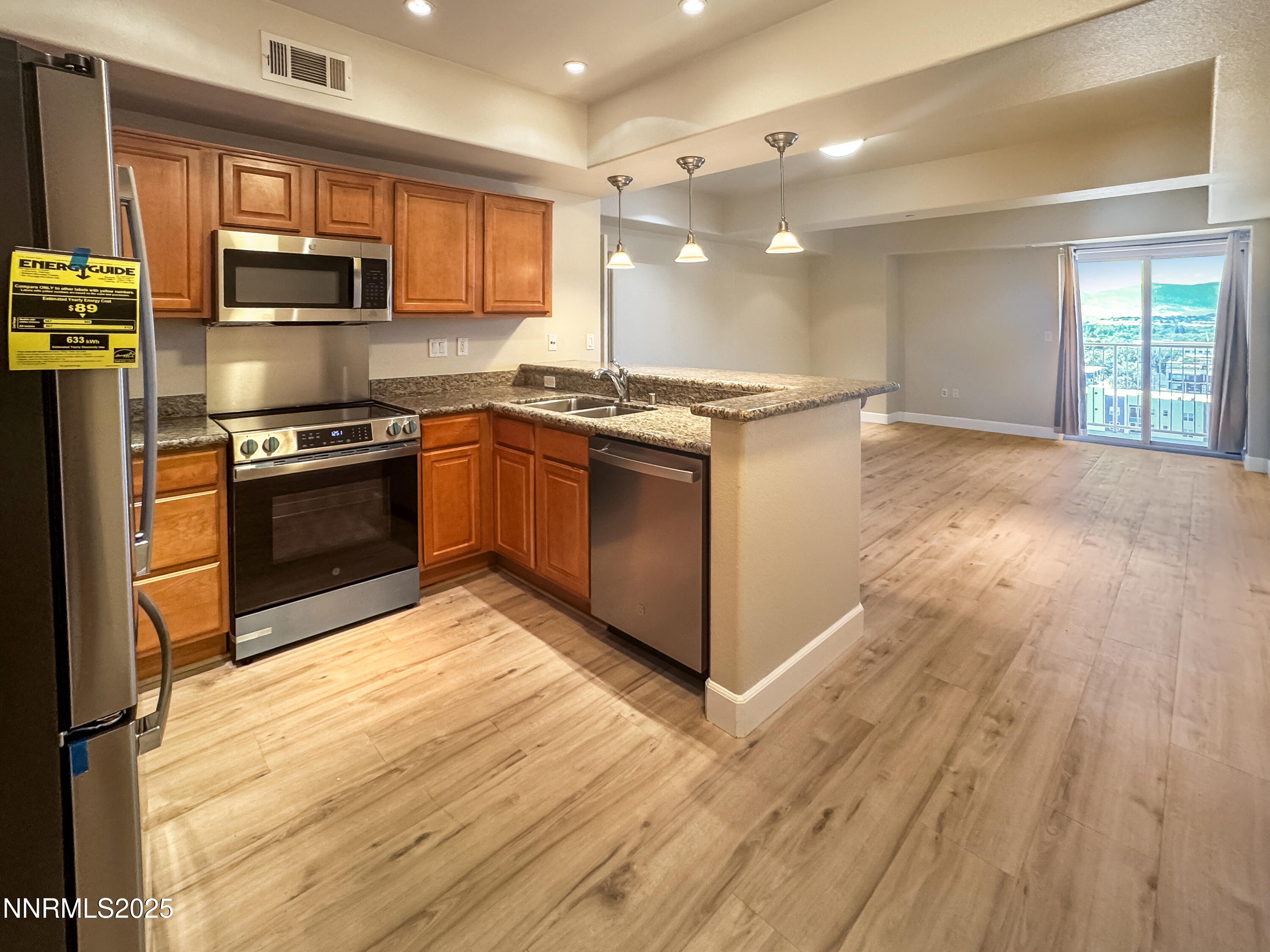 200 West 2nd Street, Unit 1107 Reno, NV 89501 - Photo 4 of 29 a kitchen with stainless steel appliances granite countertop a stove a sink and a refrigerator