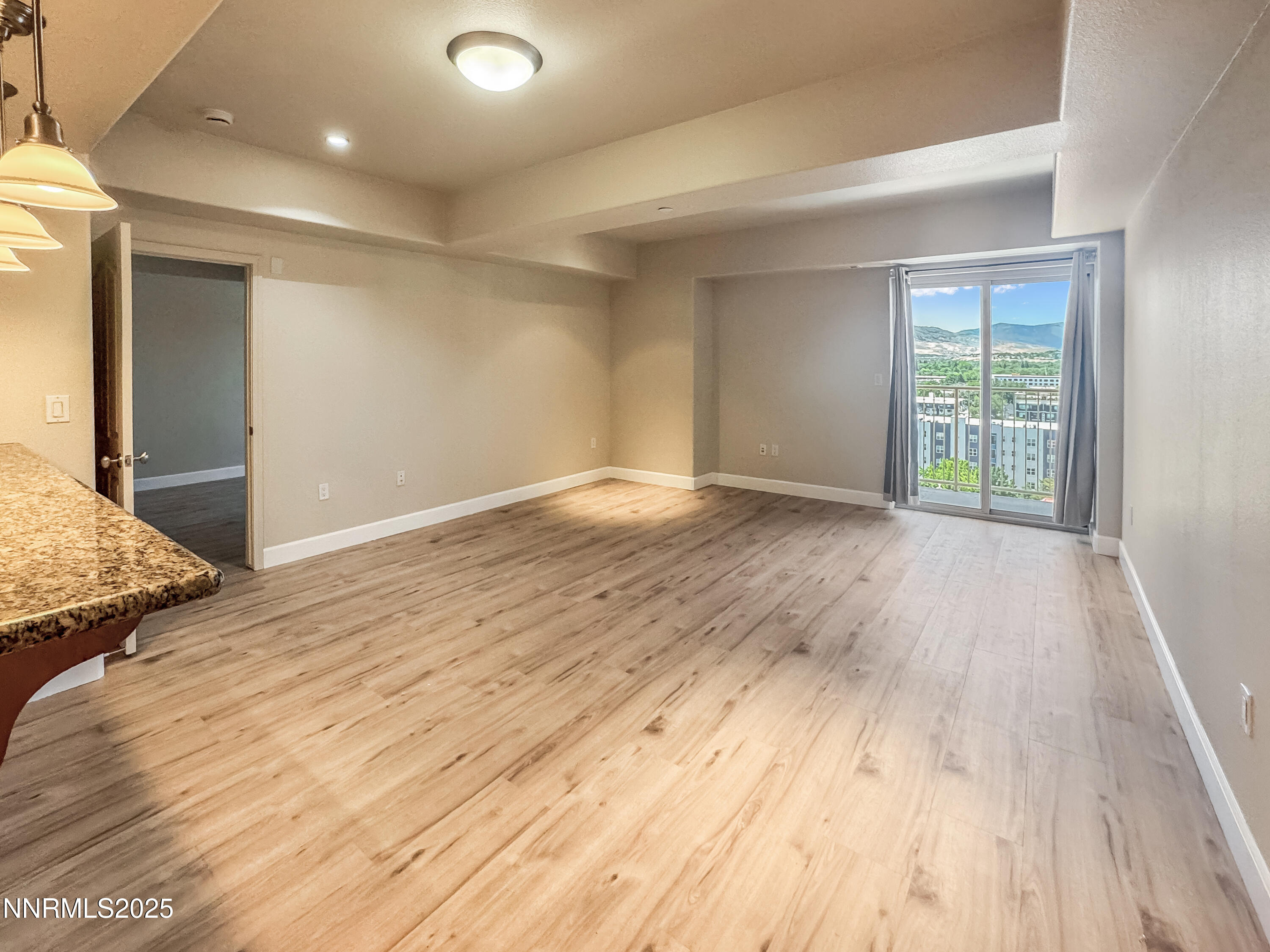 200 West 2nd Street, Unit 1107 Reno, NV 89501 - Photo 5 of 29 a view of an empty room with wooden floor and a window