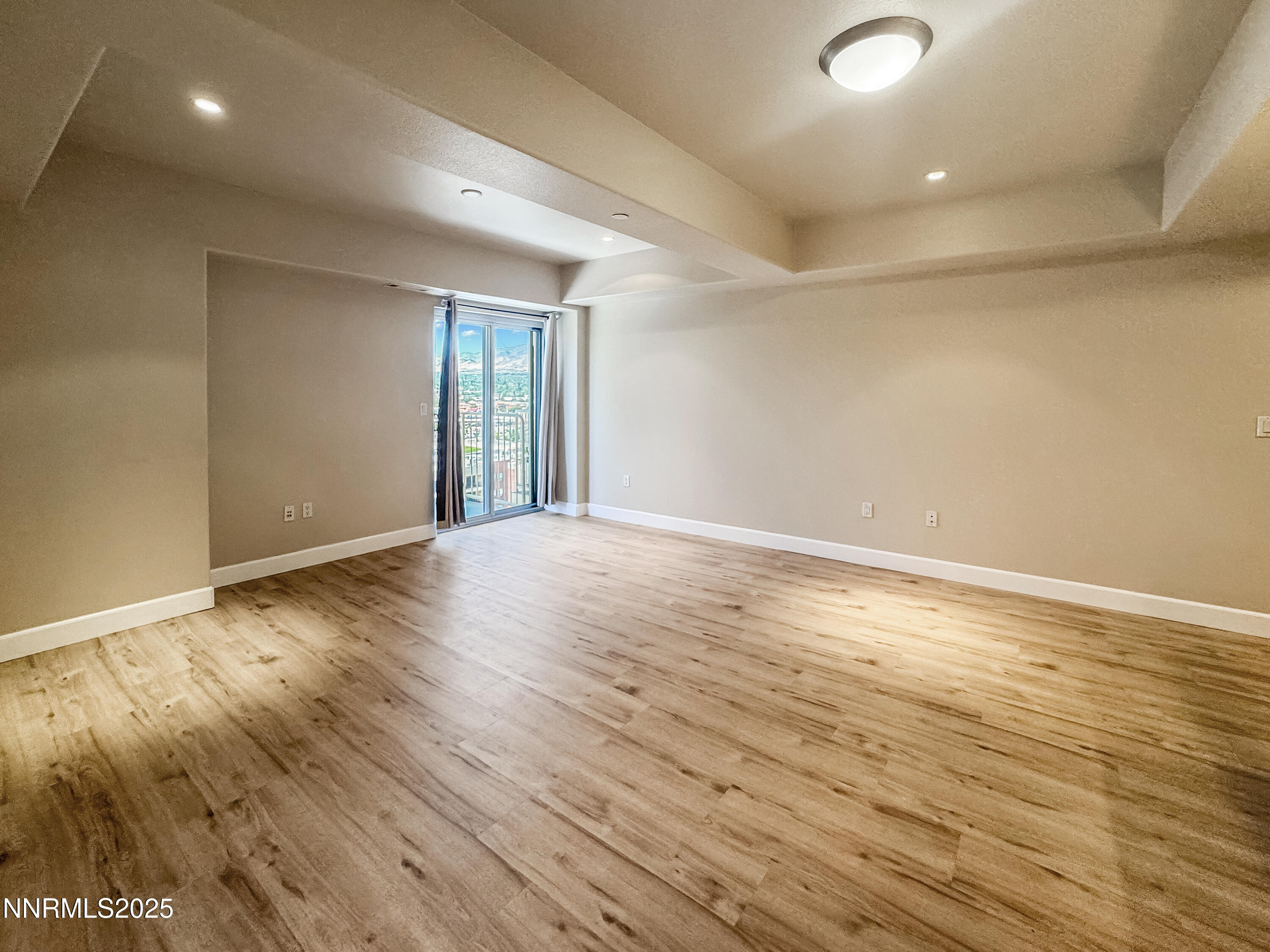 200 West 2nd Street, Unit 1107 Reno, NV 89501 - Photo 6 of 29 an empty room with wooden floor and windows