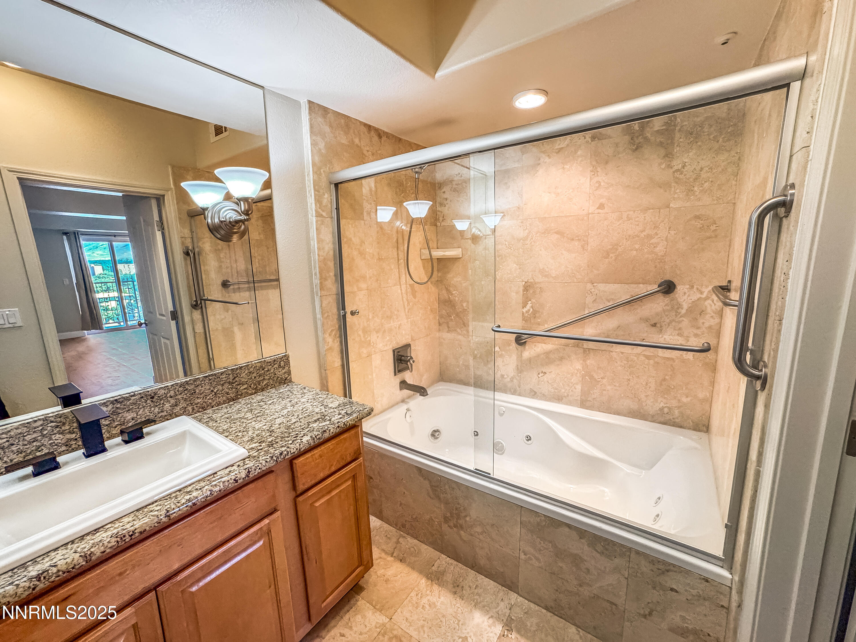 200 West 2nd Street, Unit 1107 Reno, NV 89501 - Photo 7 of 29 a bathroom with a granite countertop sink a bathtub and a shower