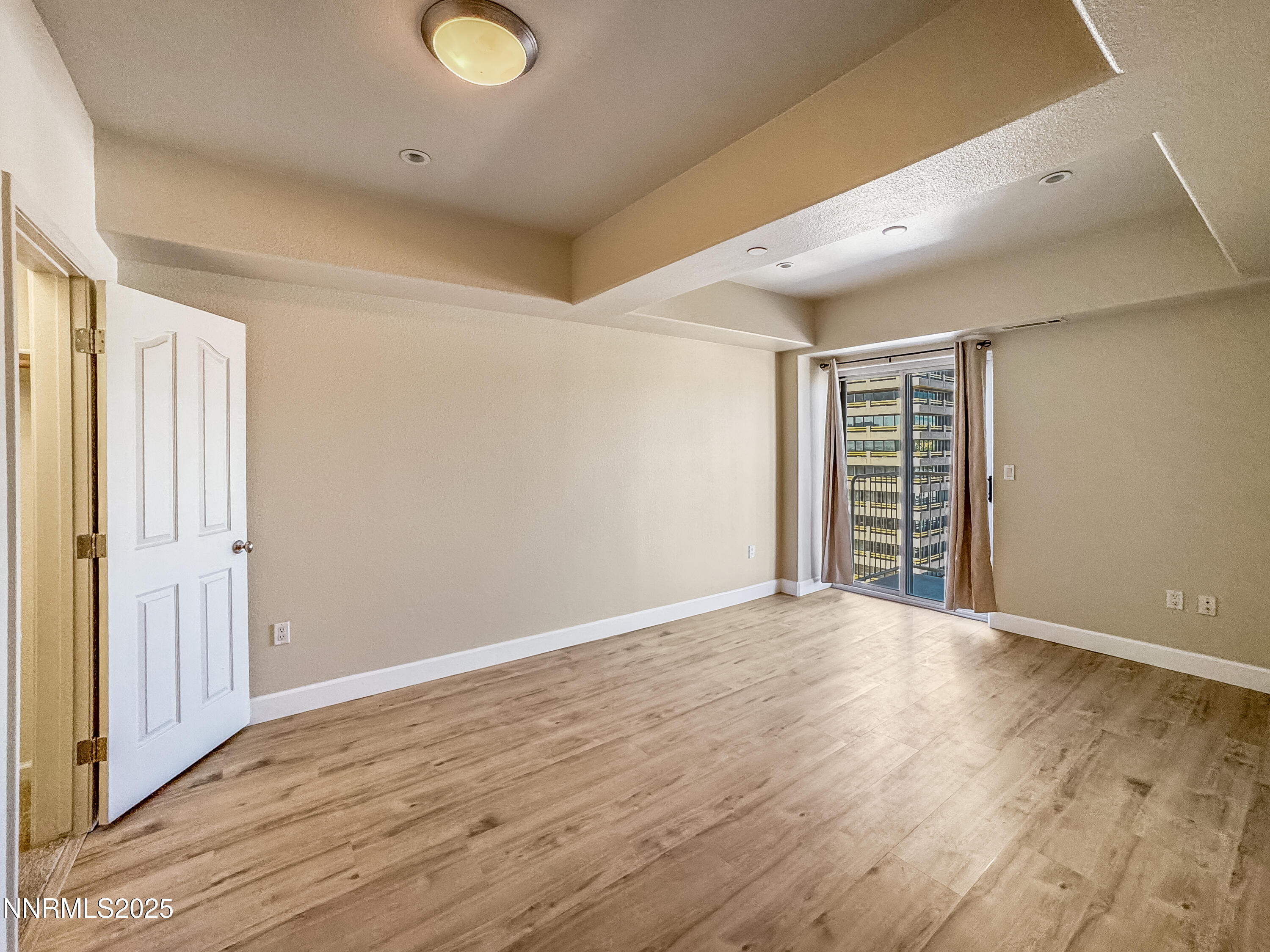 200 West 2nd Street, Unit 1107 Reno, NV 89501 - Photo 9 of 29 wooden floor in an empty room with a window