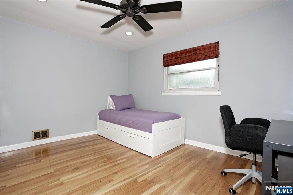87 Barbara Road Dumont, NJ 07628 - Photo 23 of 48 a bedroom with a bed and a chair