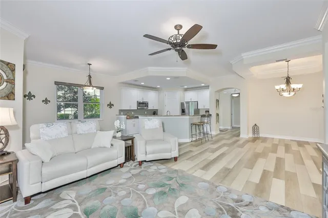 a living room with furniture and a chandelier