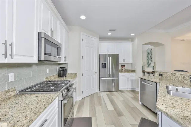 a kitchen with a sink stove and refrigerator
