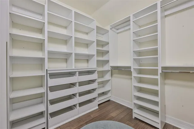 a view of walk in closet with empty racks