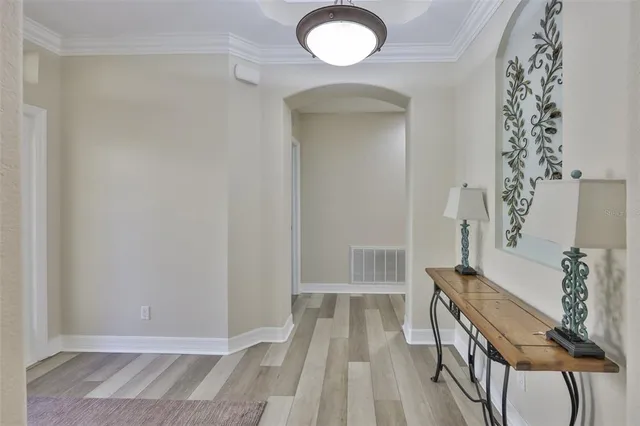 a view of a livingroom with wooden floor and furniture