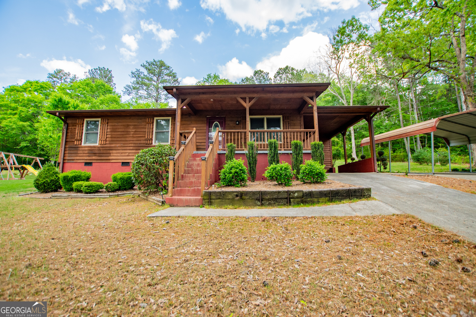 front view of house with a yard and potted plants
