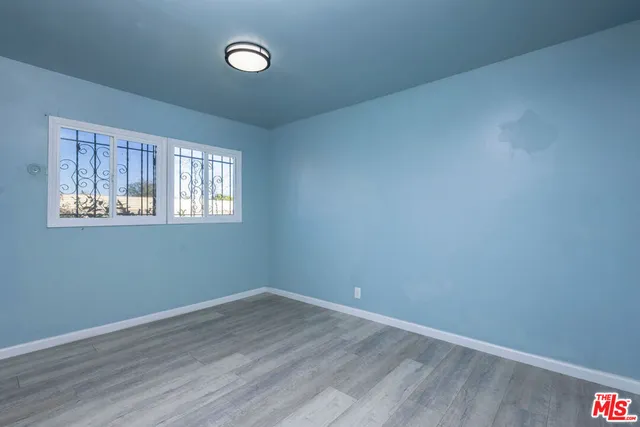 a view of a livingroom with entryway wooden floor and a chandelier fan