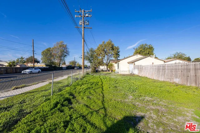 a view of backyard of house with green space