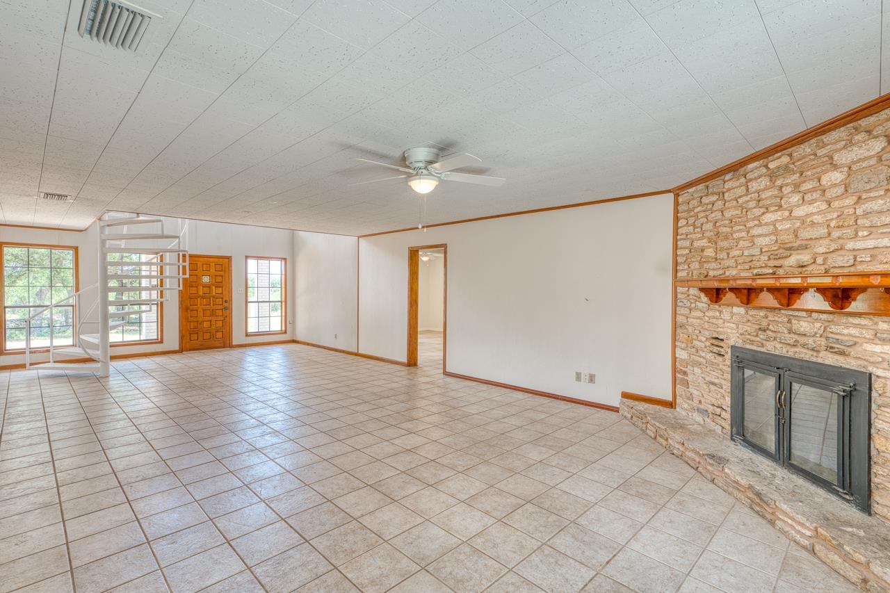 6552 Cr 403 Valley Spring Llano, TX 78643 - Photo 12 of 30 an empty room with windows and fireplace