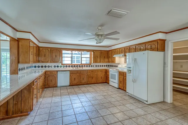 a large kitchen with cabinets and stainless steel appliances