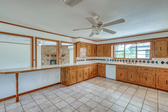 a large kitchen with a large window appliances and cabinets