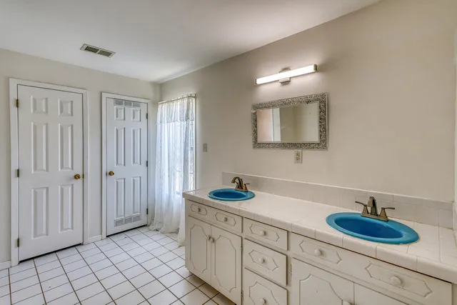 a bathroom with a sink double vanity and a mirror