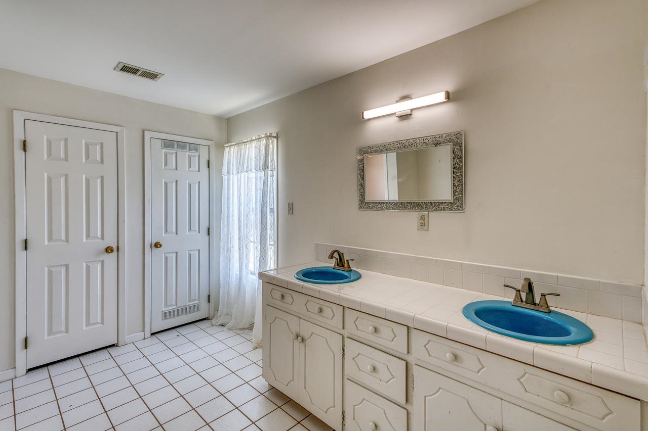6552 Cr 403 Valley Spring Llano, TX 78643 - Photo 22 of 30 a bathroom with a sink double vanity and a mirror