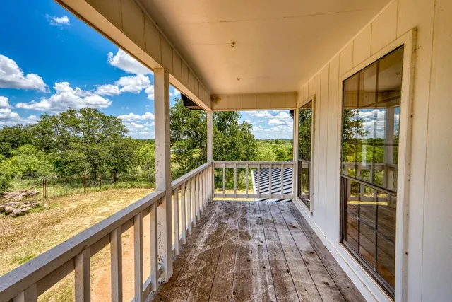 a view of balcony with wooden floor