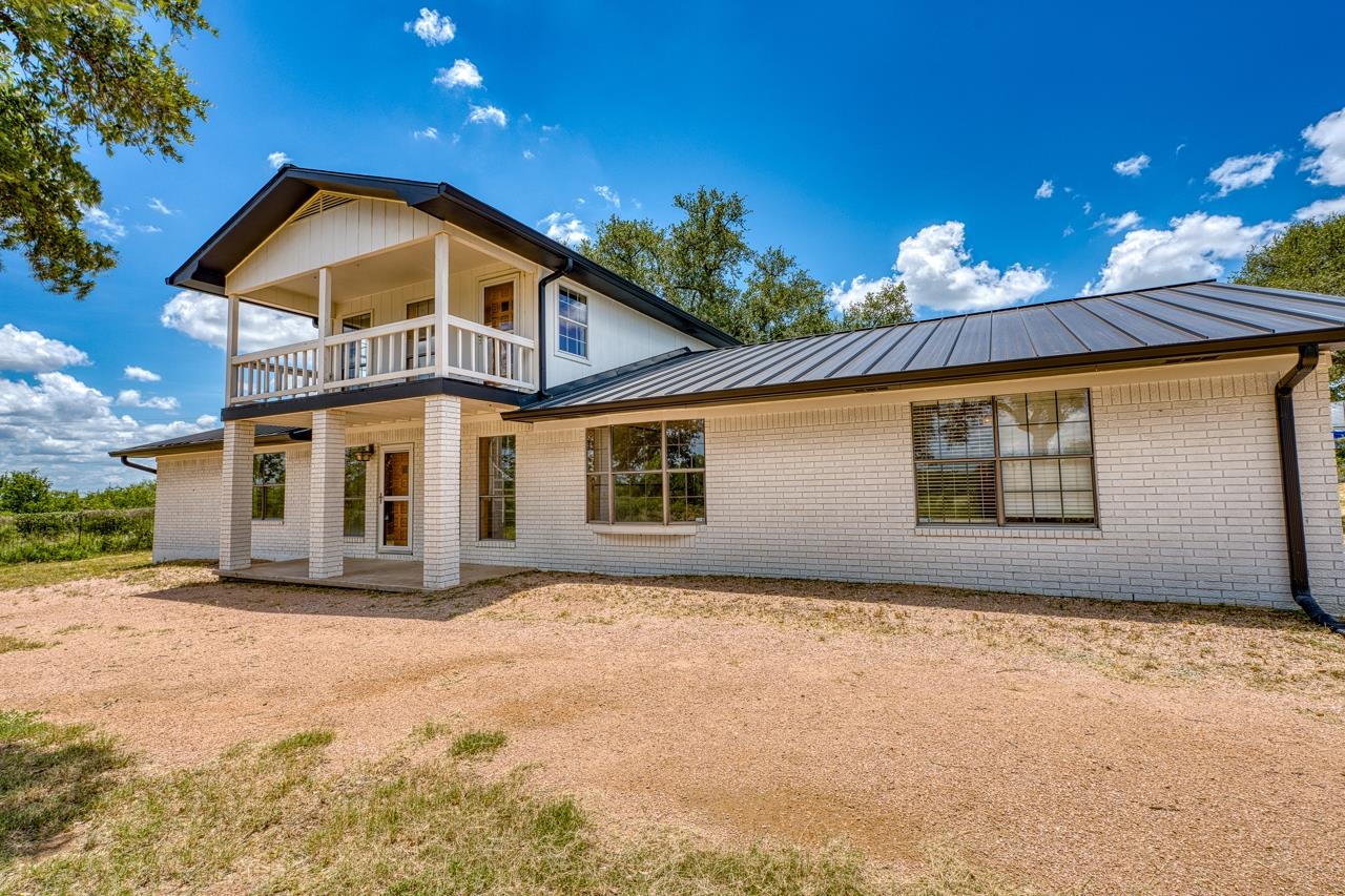 6552 Cr 403 Valley Spring Llano, TX 78643 - Photo 3 of 30 a front view of a house with a yard