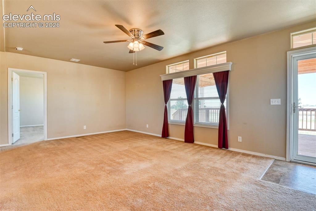 22558 Enoch Road Calhan, CO 80808 - Photo 4 of 50 an empty room with windows and fan
