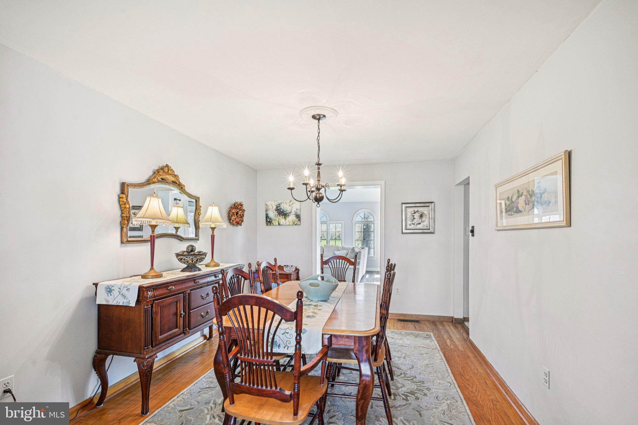 25618 Mt Pleasant Road Columbus, NJ 08022 - Photo 13 of 61 a view of a dining room with furniture a chandelier and wooden floor
