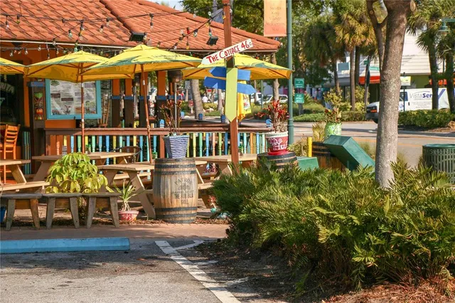 an aerial view of a house with a garden and lake view