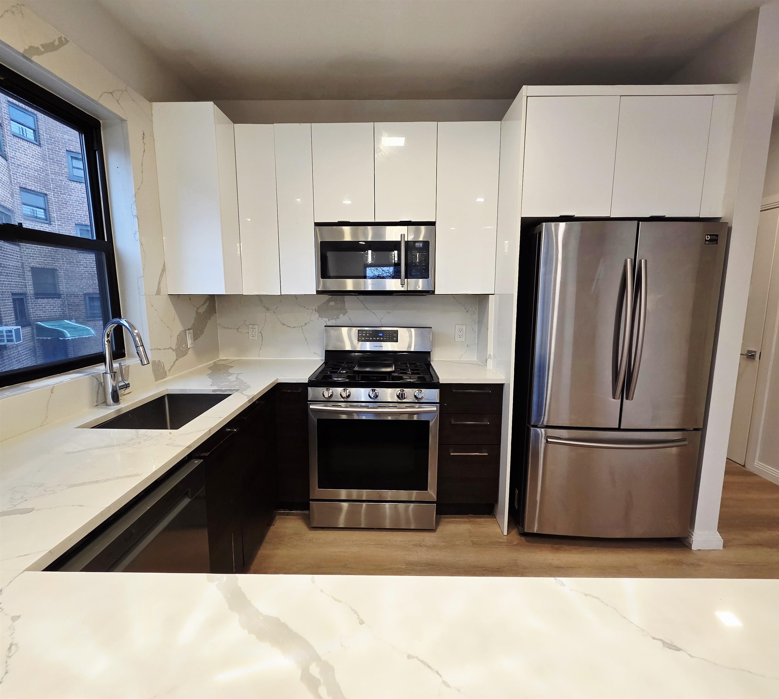 6809 Palisade Avenue, Unit 201 Guttenberg, NJ 07093 - Photo 4 of 11 a kitchen with a refrigerator stove and sink