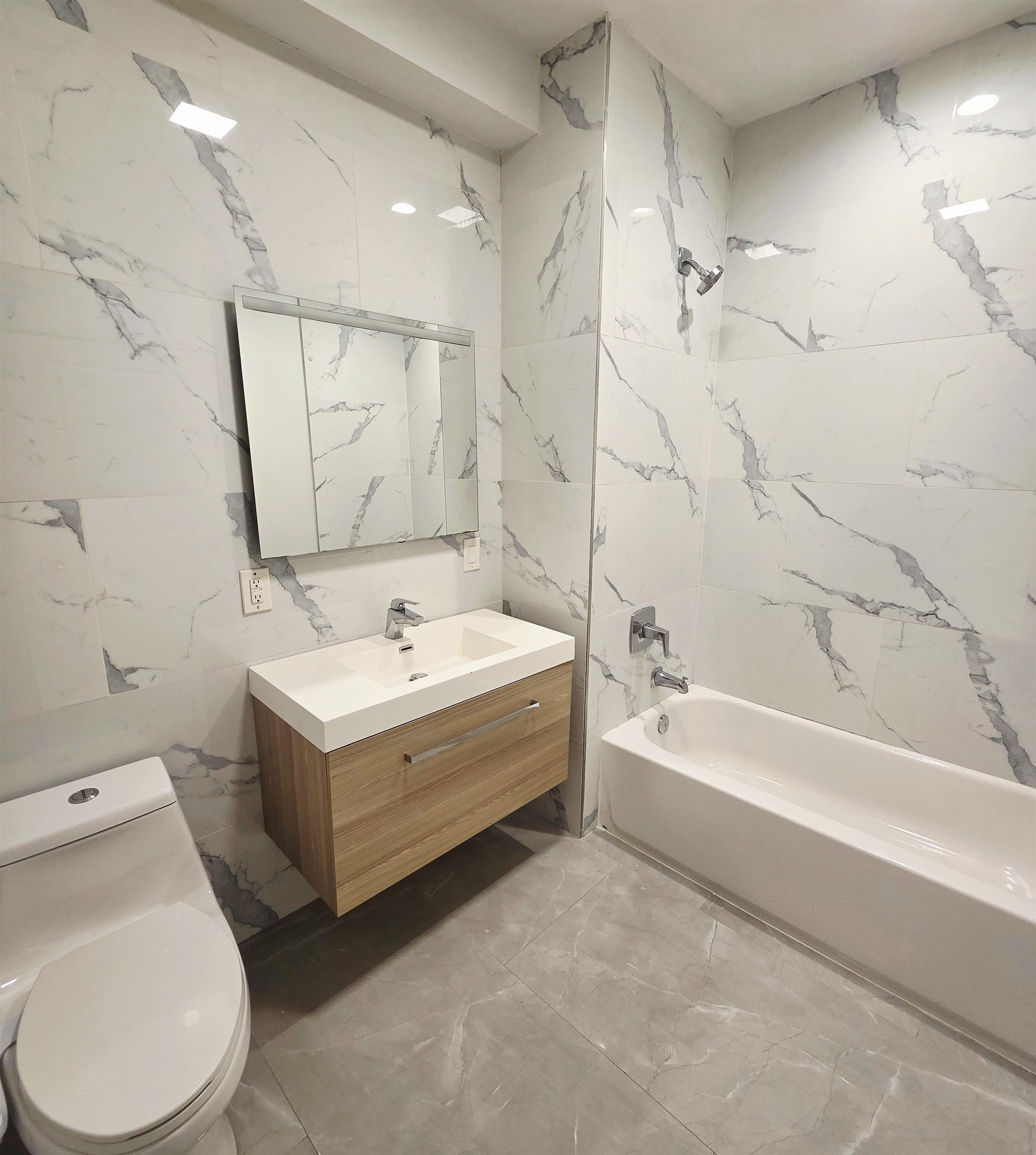 6809 Palisade Avenue, Unit 201 Guttenberg, NJ 07093 - Photo 6 of 11 a bathroom with a sink a toilet and a bathtub