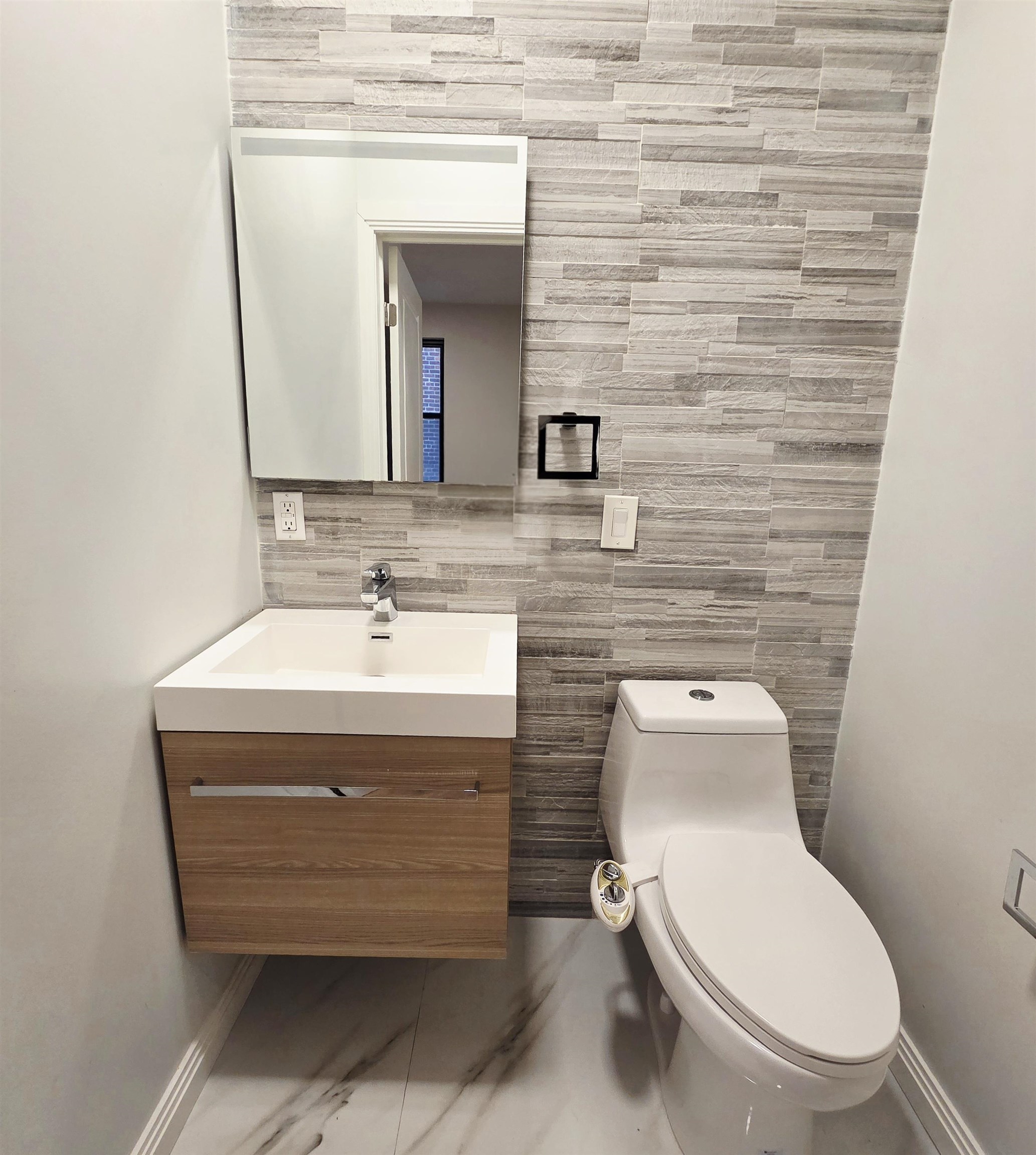 6809 Palisade Avenue, Unit 201 Guttenberg, NJ 07093 - Photo 8 of 11 a bathroom with a toilet a sink and mirror