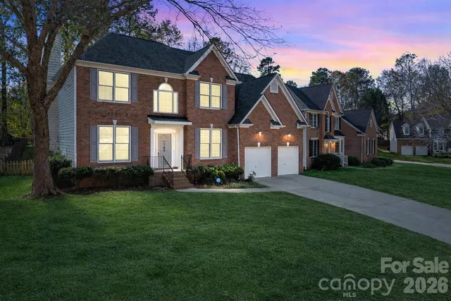 a living room with furniture a dining table and a large window
