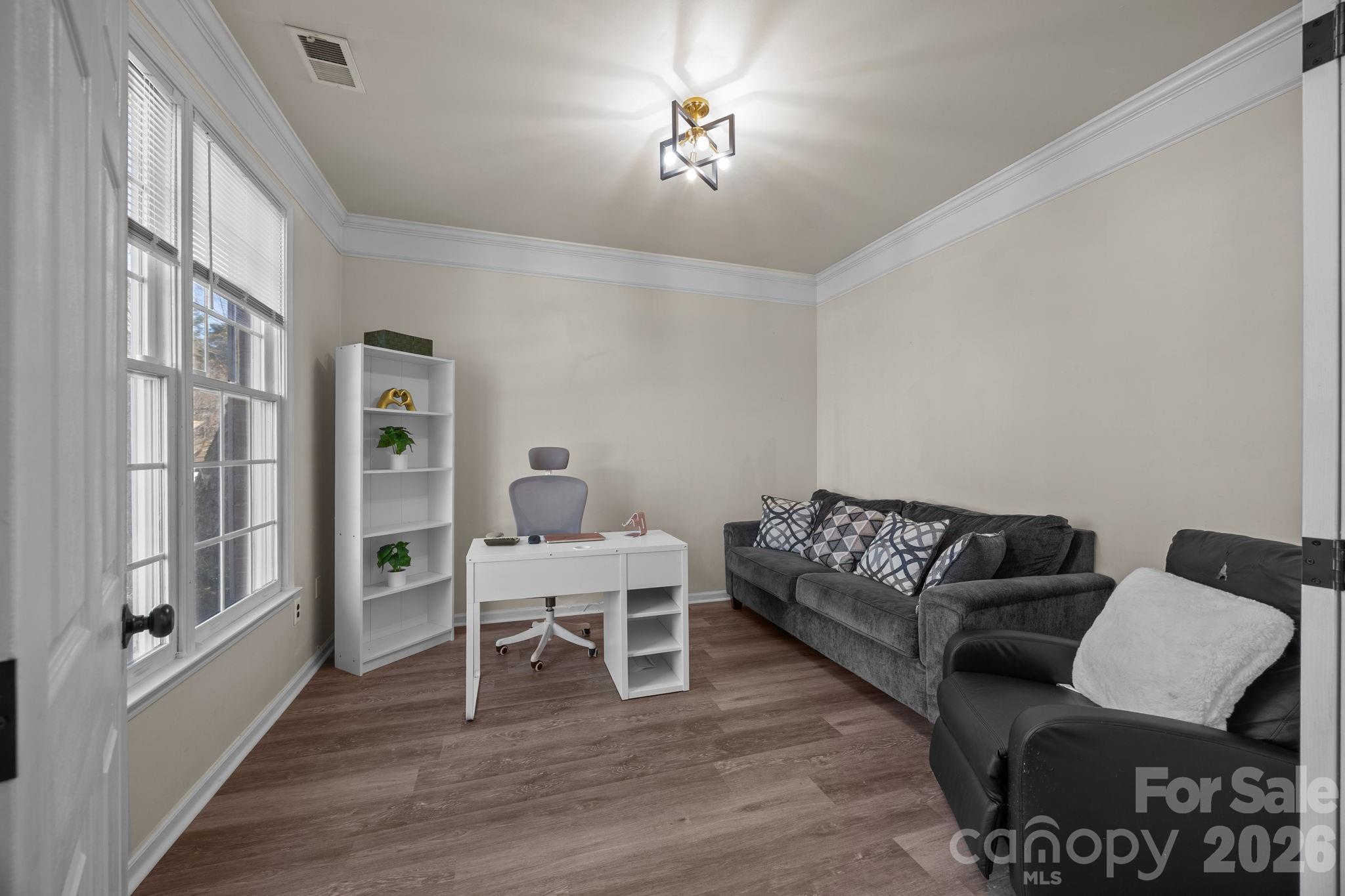 7708 Harrington Woods Road Charlotte, NC 28269 - Photo 9 of 35 a living room with furniture and a wooden floor