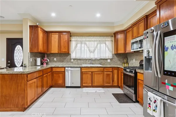 a kitchen with stainless steel appliances granite countertop a stove sink and cabinets